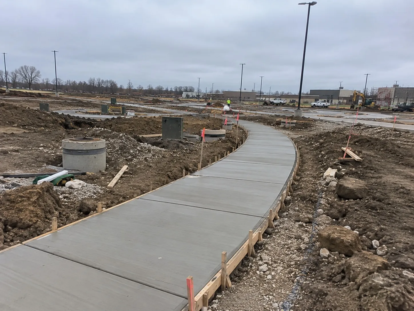 Freshly poured concrete footpath with timber boxing on a Hamilton development