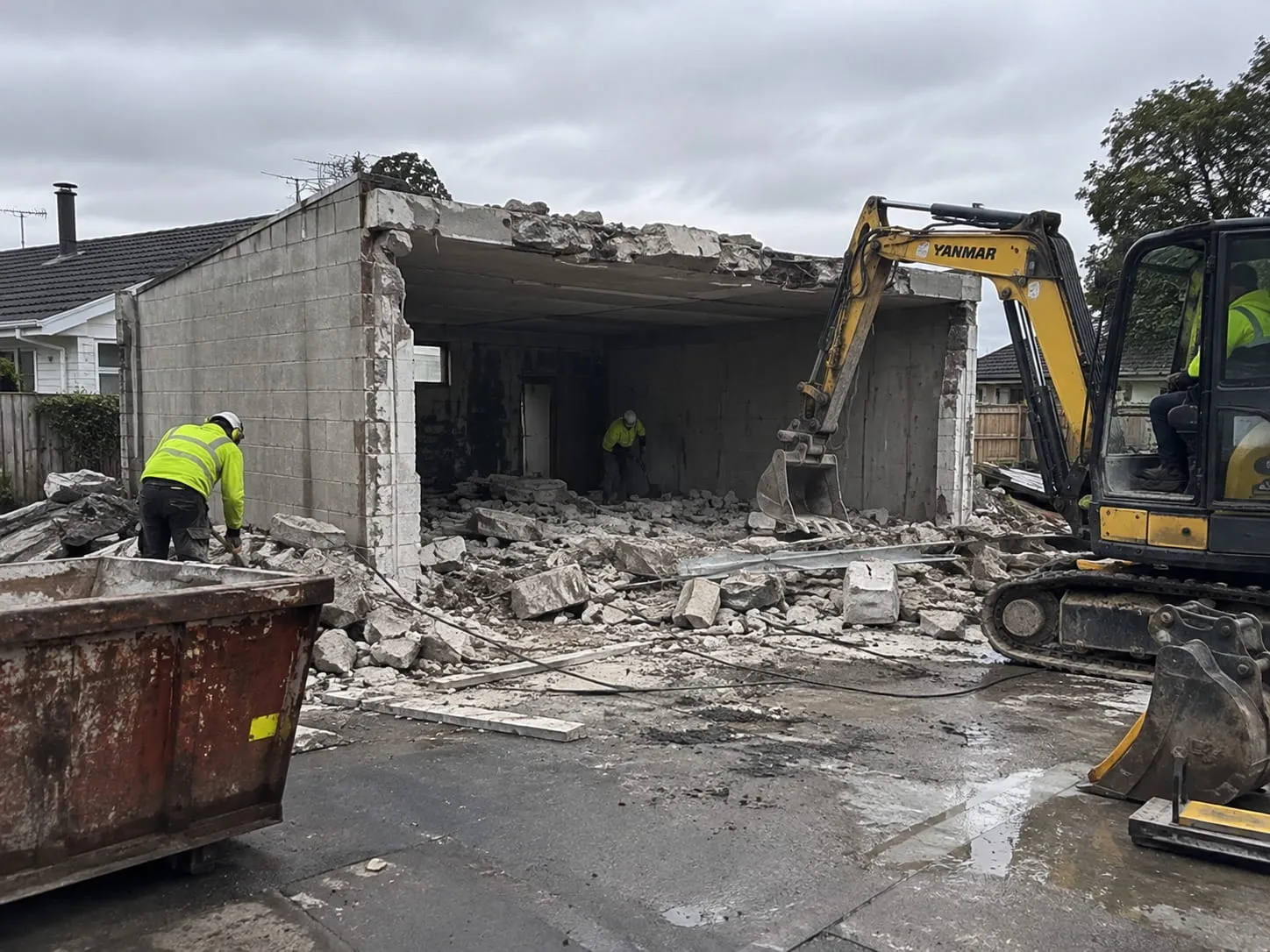 Old garage and outbuilding being demolished on a residential Hamilton section